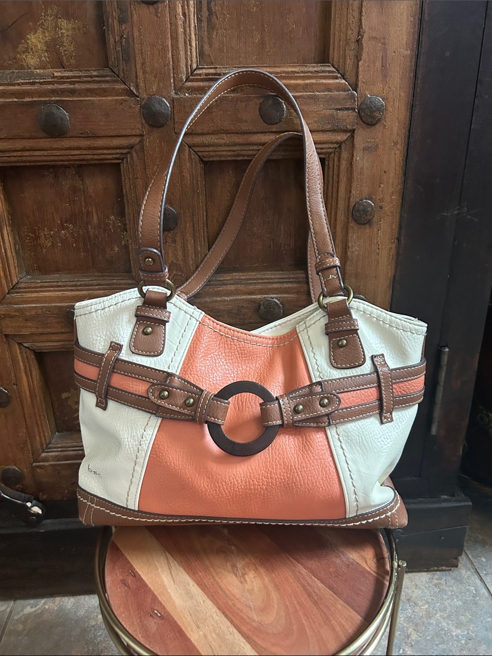 b.o.c. (Born Concept) handbag features a distinct brown wooden ring buckle